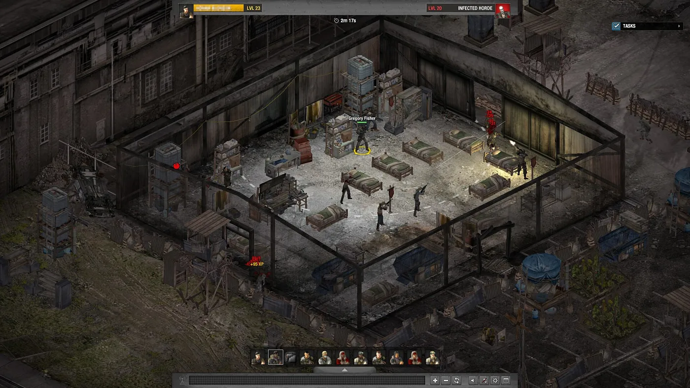 A fenced survivor compound in an industrial lot in Dead Zone Revive, with beds, storage shelving and several armed survivors inside the perimeter, seen from an isometric angle.